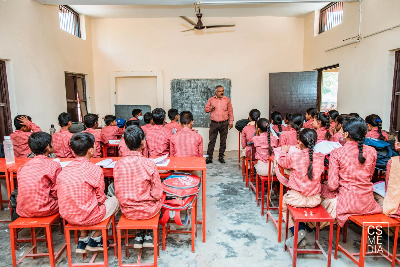 Corporate CSR Photographer capturing students during a company's education initiative for their ESG report.