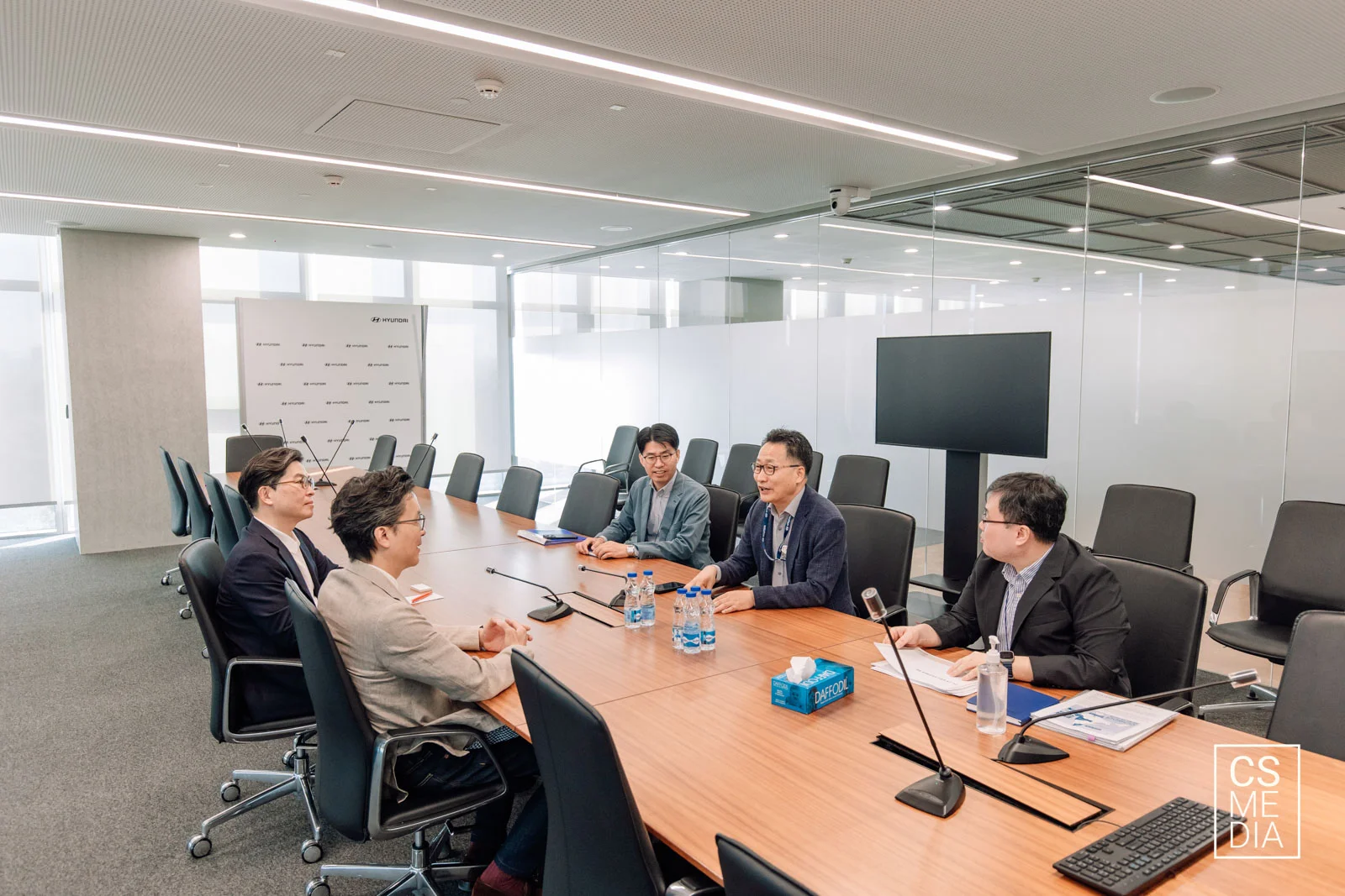 Corporate Lifestyle Photography of candid team collaboration and brainstorming in a modern Gurgaon office.