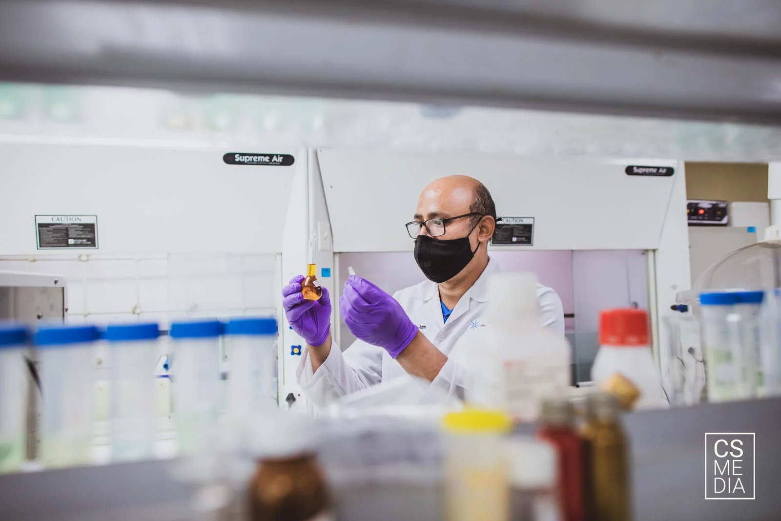 Corporate Lifestyle Photography capturing pharma lab employees testing samples and working diligently.