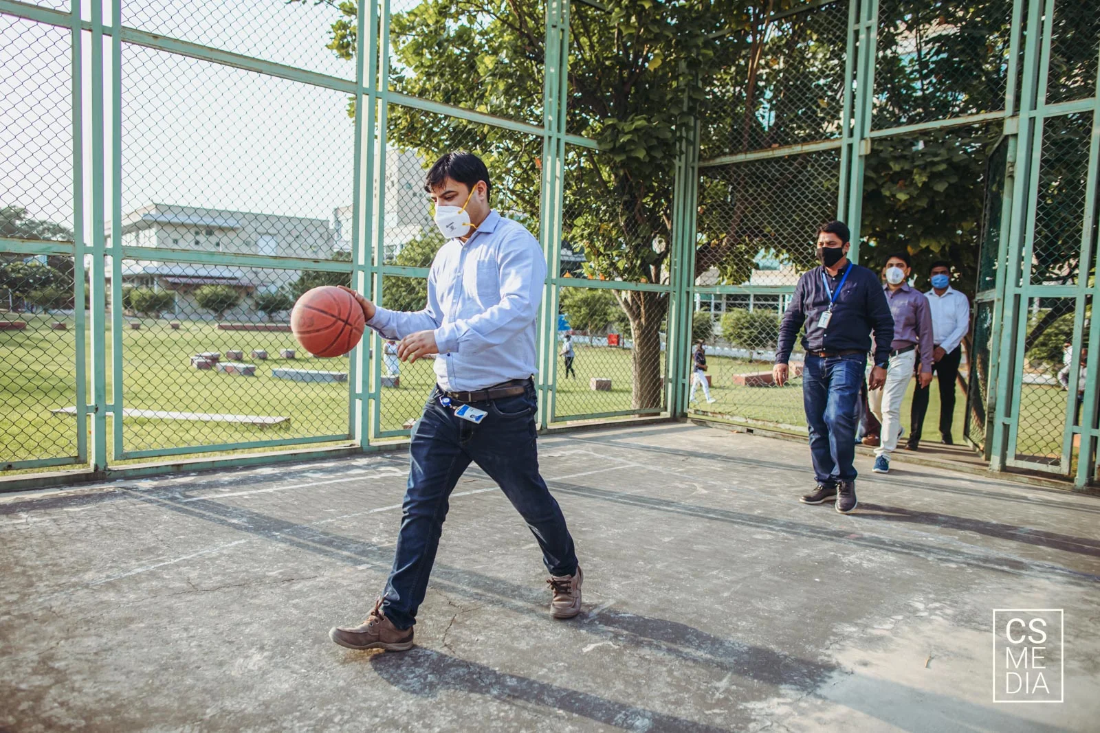Corporate Lifestyle Photography of employees playing basketball in the office leisure space for employer branding.
