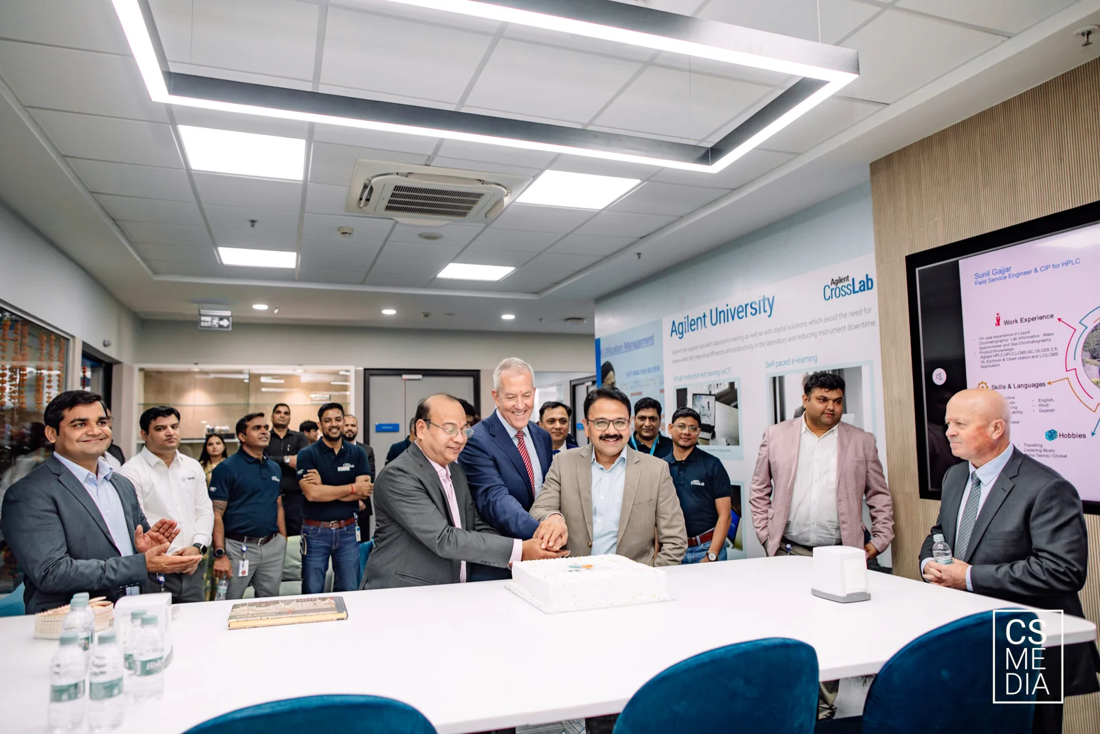 Corporate Lifestyle Photography capturing an authentic office celebration and cake cutting for internal communication.